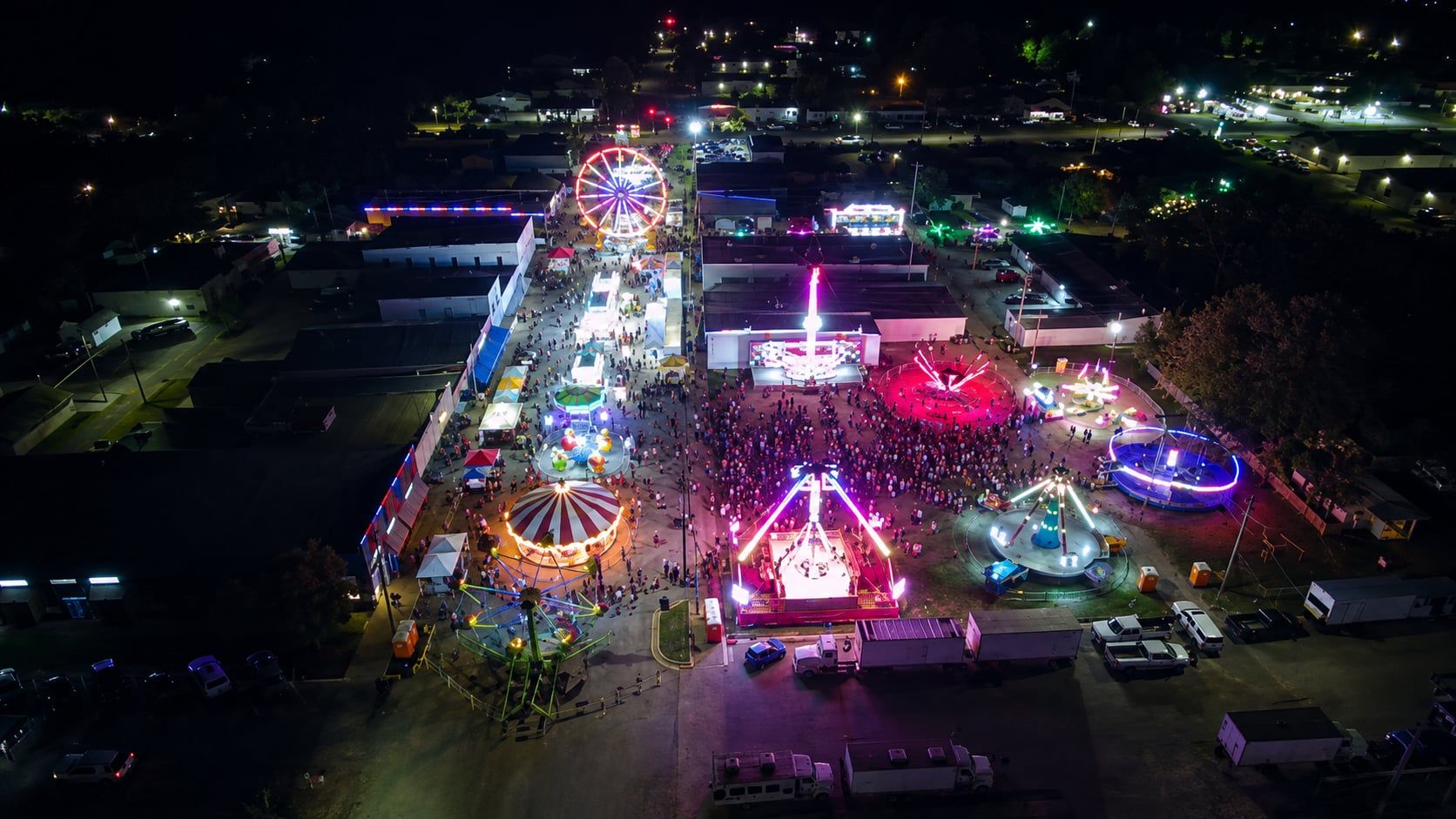 Aerial view of carnival rides and crowds at the Valley Center Fall Festival at night